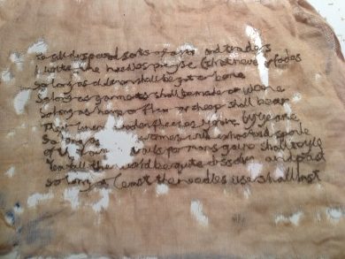 Text from ‘The Art of the Needle’ stitched on vanishing muslin and heat‑treated to resemble an aged textile.