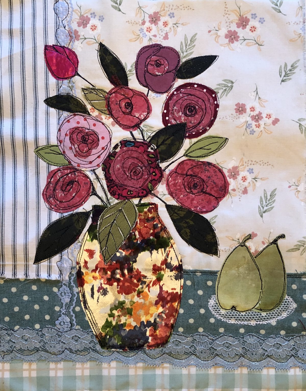Applique a Bouquet - image shows a stitched picture of a stylised vase of flowers using vintage fabrics