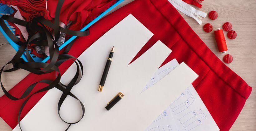 Dressmaking techniques. Image shows a skirt pattern and red fabric