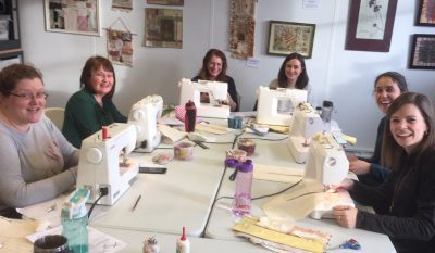 Summer Schools a- group of happy sewing students