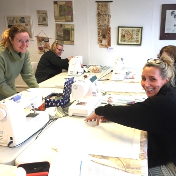 Students enjoying a relaxed sewing class at Artisan Stitch in Edinburgh, working on sewing projects in a friendly and supportive studio environment.
