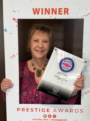 “Jen from Artisan Stitch holding her Prestige Award for 2025/26