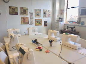 Bright sewing studio at Artisan Stitch with sewing machines set up for classes in Edinburgh